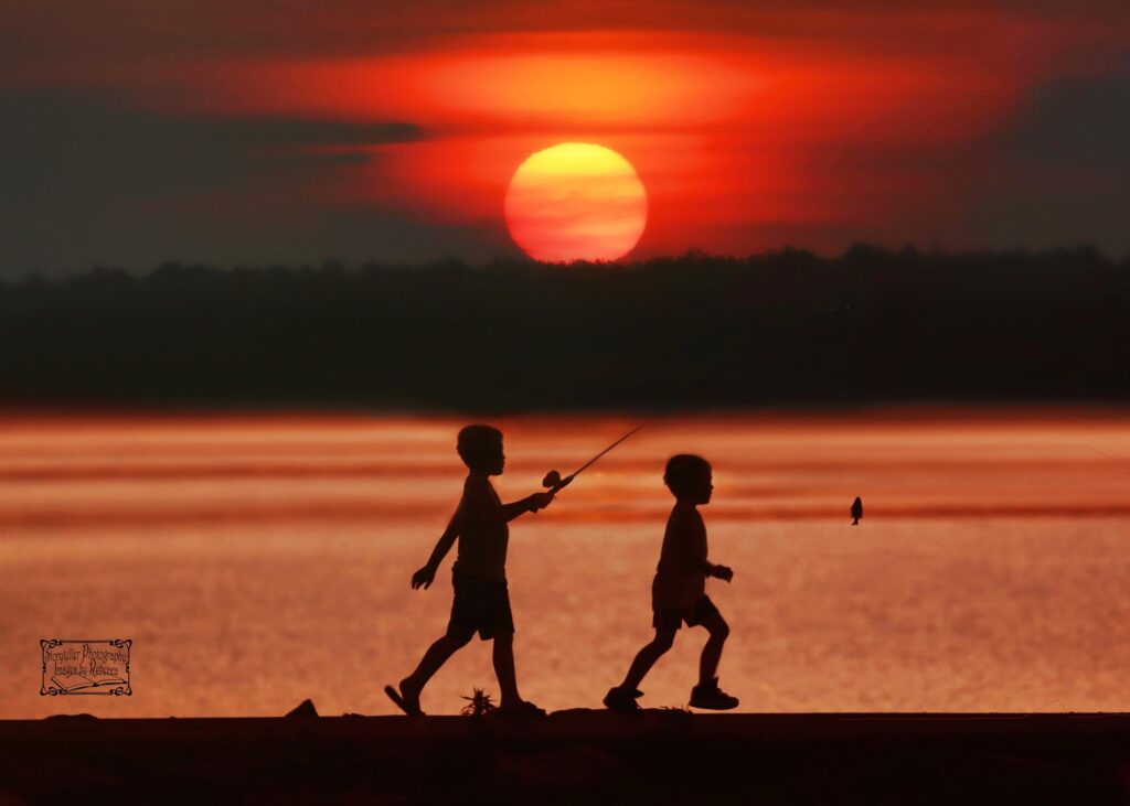 Children fishing at sunset at Mosquito Lake State Park, a popular family outdoor destination in Trumbull County, Northeast Ohio.