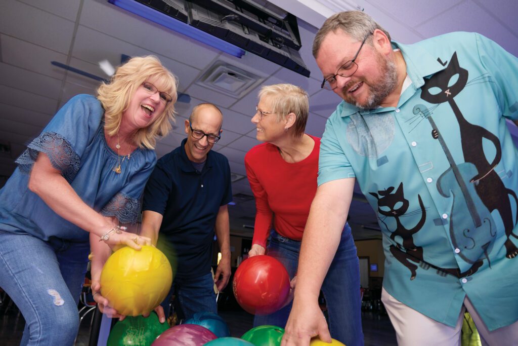 Group of adults enjoying a fun night of bowling at Champion Lanes in Champion, Ohio, a popular entertainment destination in Trumbull County.