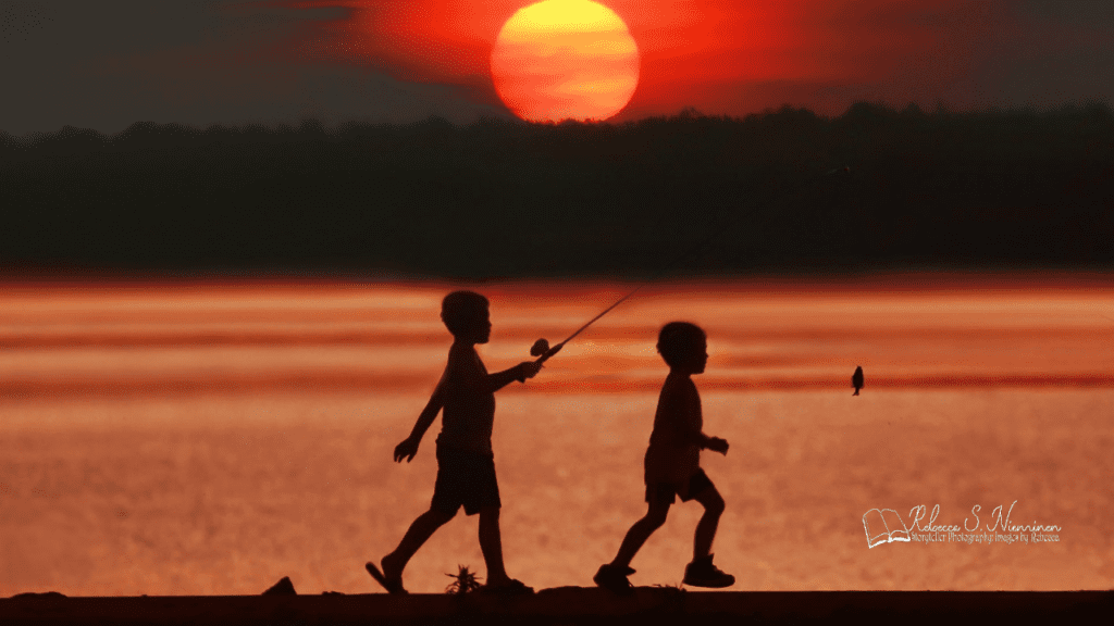 Two kids fishing at sunset along the shores of Mosquito Lake State Park in Trumbull County, Northeast Ohio.