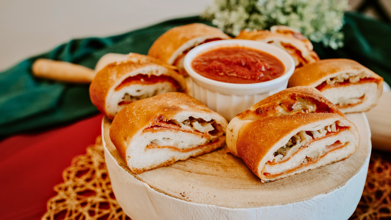 Slices of Pesa Italian Rolls filled with peppers and cheese, served with marinara sauce—an Italian Food Trail favorite in Trumbull County, Northeast Ohio.