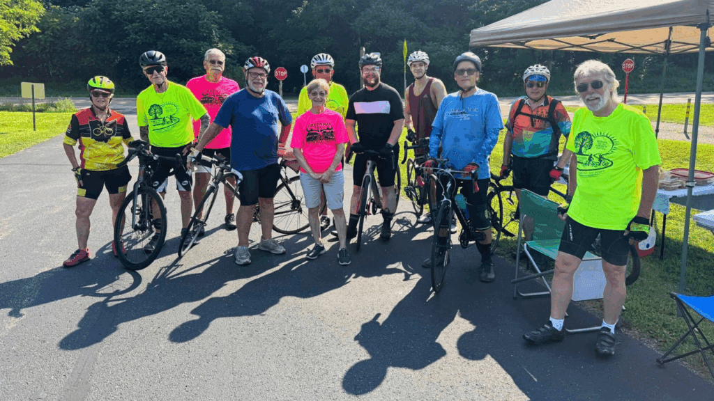 Group of cyclists posing at a rest stop during the Northeast Ohio Century bicycle tour in Trumbull County, Ohio.
