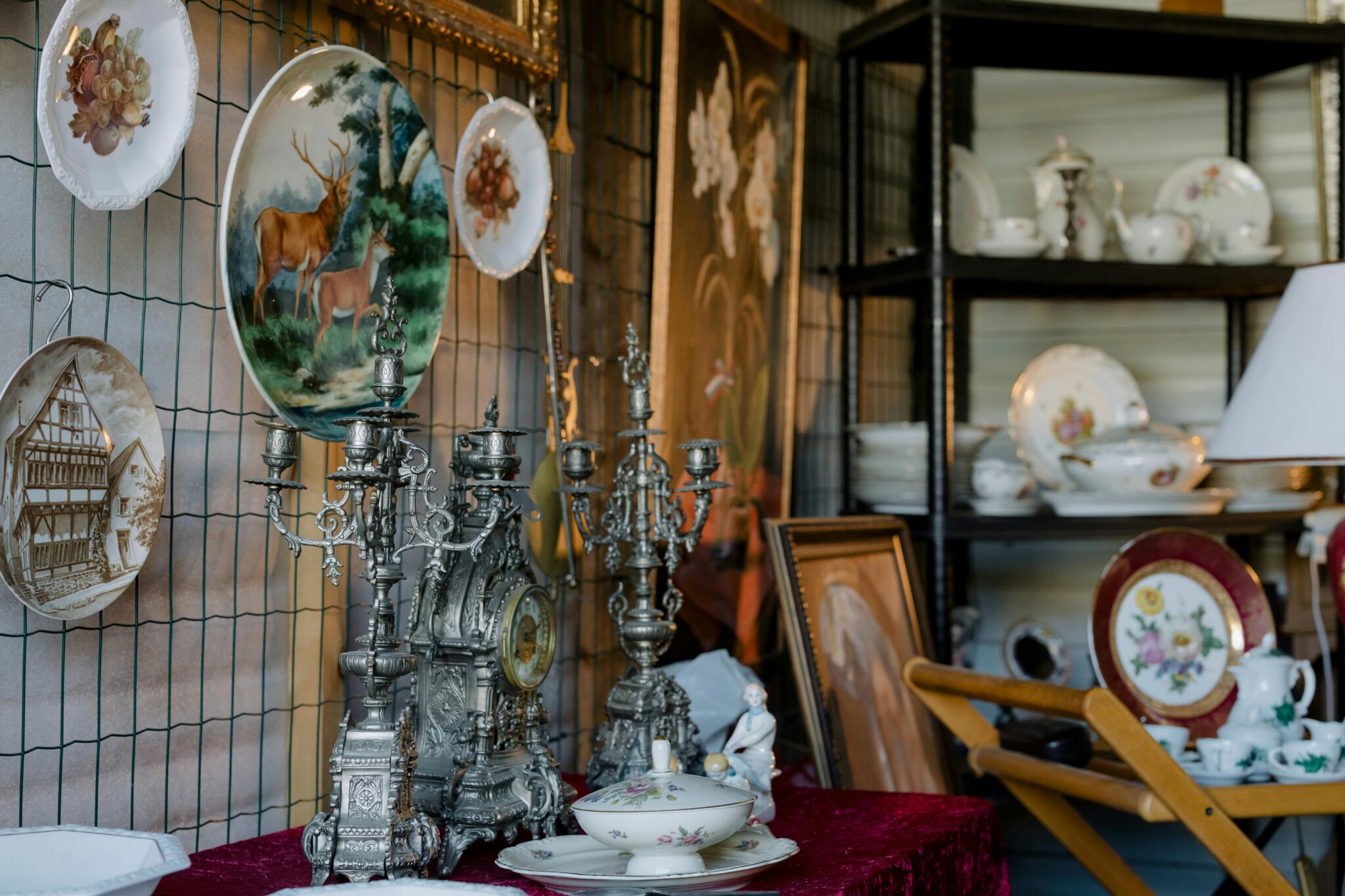 Antique porcelain plates, clocks, and collectibles showcased at Ohio Route 7 60-Mile Yard Sale in Northeast Ohio.
