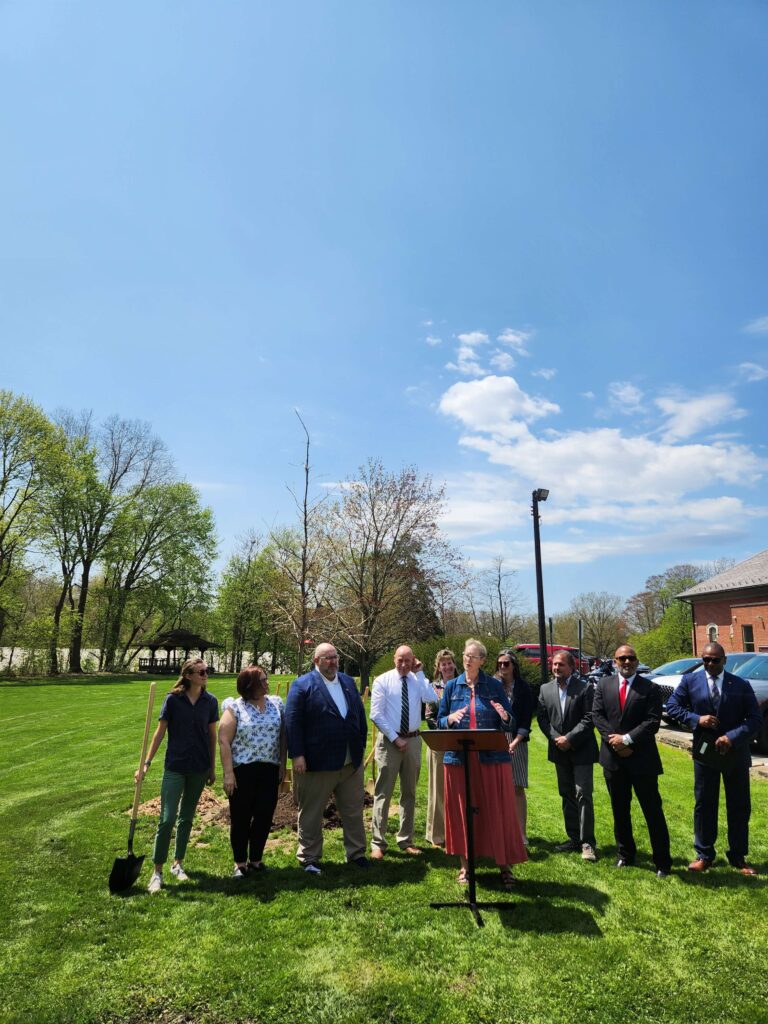 Trumbull County officials and partners stand beside newly planted white oak for America 250-Ohio Heritage Tree dedication in Warren, Ohio.