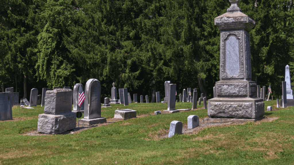 Stone monument surrounded by 19th-century gravestones at Braceville Township Cemetery in Trumbull County, Ohio, resting place of pioneers and veterans.