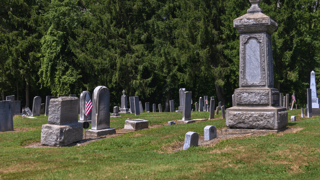Stone monument surrounded by 19th-century gravestones at Braceville Township Cemetery in Trumbull County, Ohio, resting place of pioneers and veterans.
