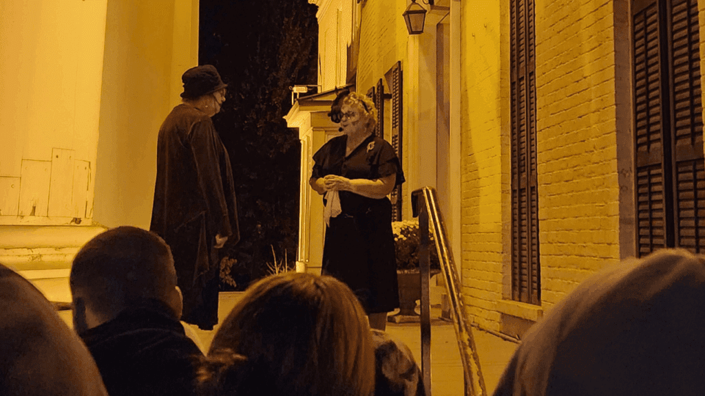 Performers tell a haunted tale outside a columned historic building on Millionaires’ Row as visitors watch during the Warren Ghost Walk in Warren, Ohio.
