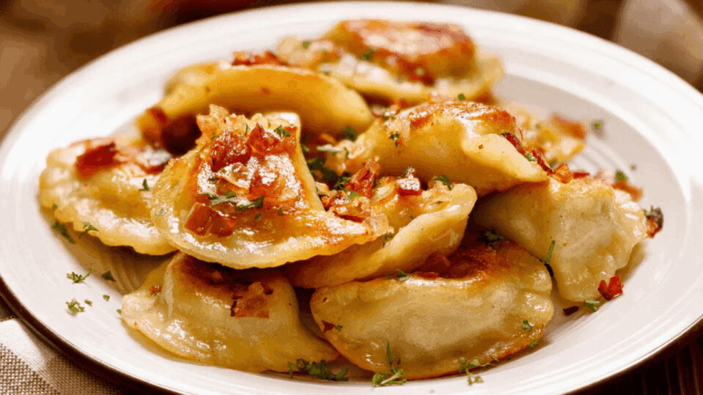 Golden pierogies with butter and onions at Lena’s Pierogi House in Hubbard, Ohio, a local favorite for authentic Polish comfort food.