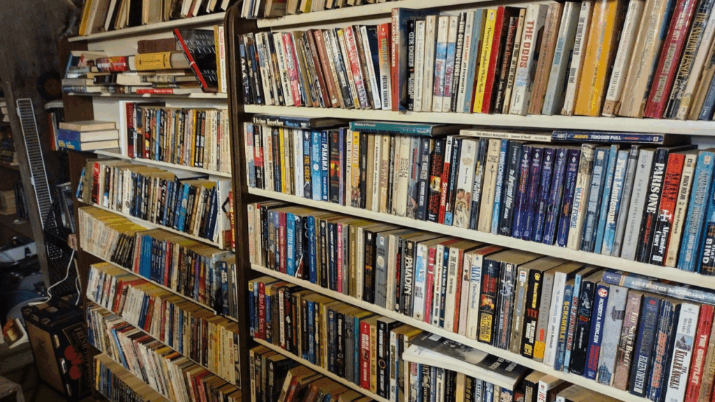 Rows of well-organized shelves packed with paperbacks and hardcovers inside Market Square, a large used bookstore in Kinsman, Trumbull County, Ohio.