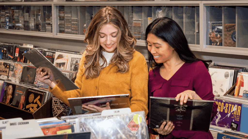 Two shoppers browsing vinyl albums at The Record Connection in Niles, Ohio, a local favorite for vintage music and record collectors.