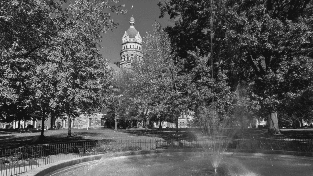 Tree-lined Courthouse Square fountain with the Trumbull County Courthouse dome in the background, downtown Warren, Ohio.