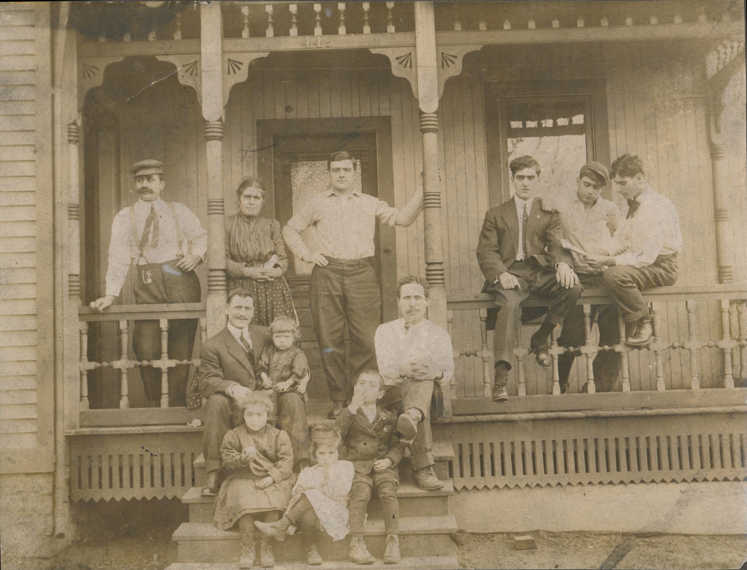  Italian American family on the front porch of their Trumbull County, Ohio home in the early 1900s, representing the family traditions behind Northeast Ohio Italian food.