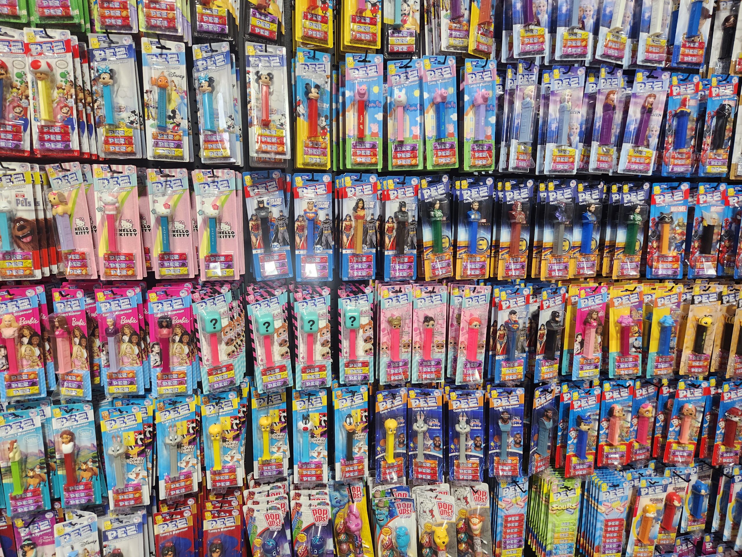 A bright and colorful wall of PEZ dispensers at Sweet Memories Vintage Tees and Candy.